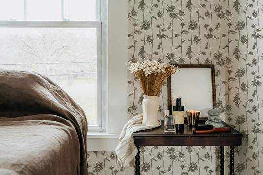 Sage green floral wallpaper in cozy bedroom with vintage decor.