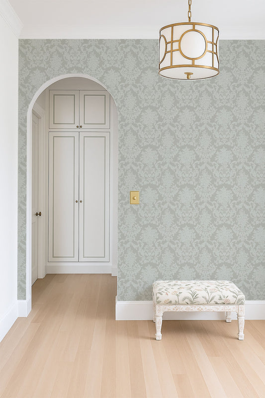 Sage neutral damask wallpaper in elegant room with archway and bench.